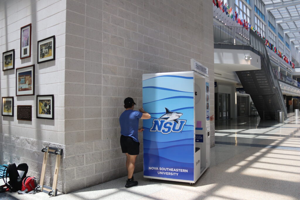 The completed permanent photo booth installation seen from across the University Center corridor