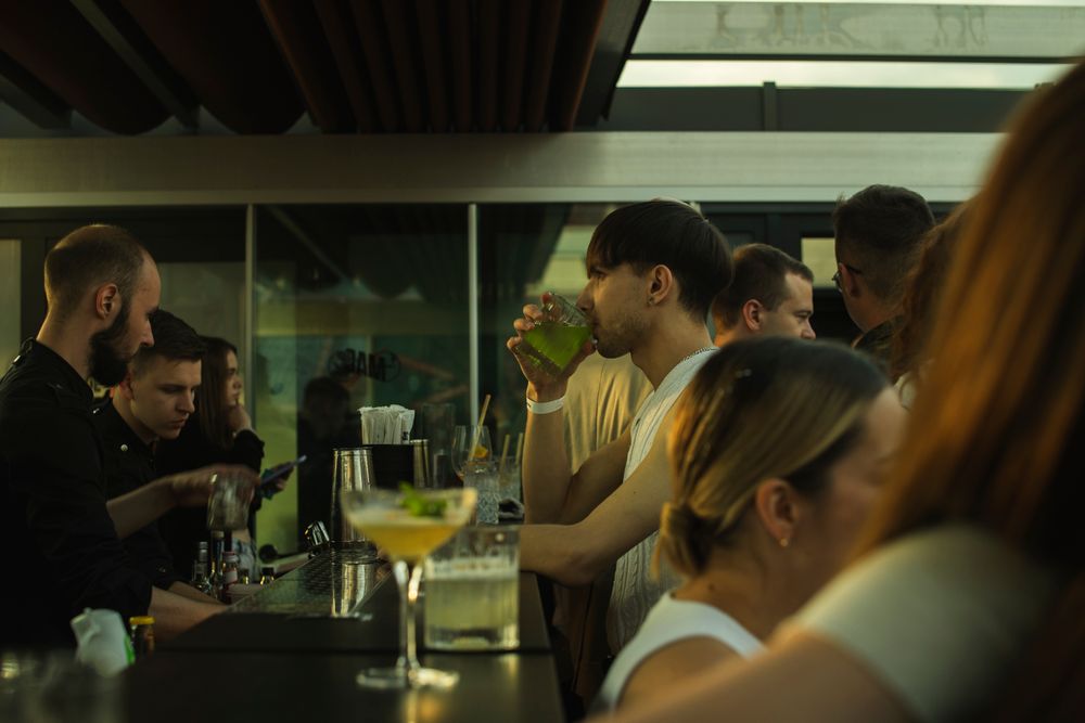 A crowded bar at night with guests waiting at the counter, the moment most bar entertainment ideas are trying to fill