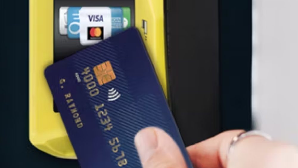 A guest tapping a contactless card on the payment reader of a photo booth
