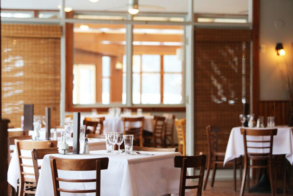 A full-service restaurant dining room during service, the kind of room where a photo booth for restaurants gets placed