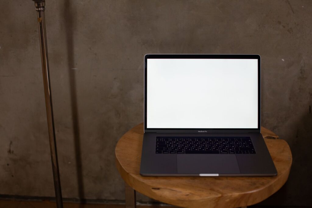 A thin laptop open on a table, the class of PC most mobile photo booth operators bring to an event