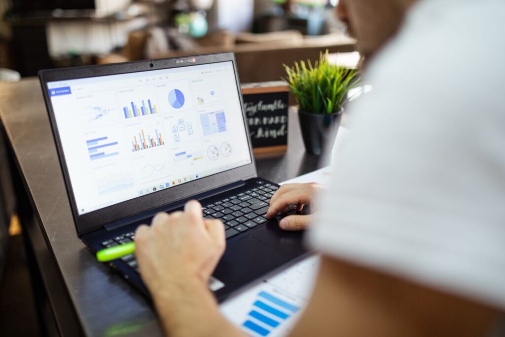 Laptop showing charts and figures, what vending machine management software reports