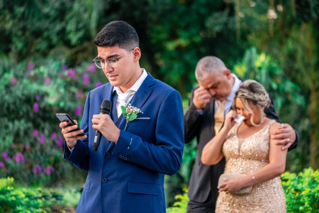 Wedding guests laughing together outdoors, the moment a video guest book booth is set up to capture