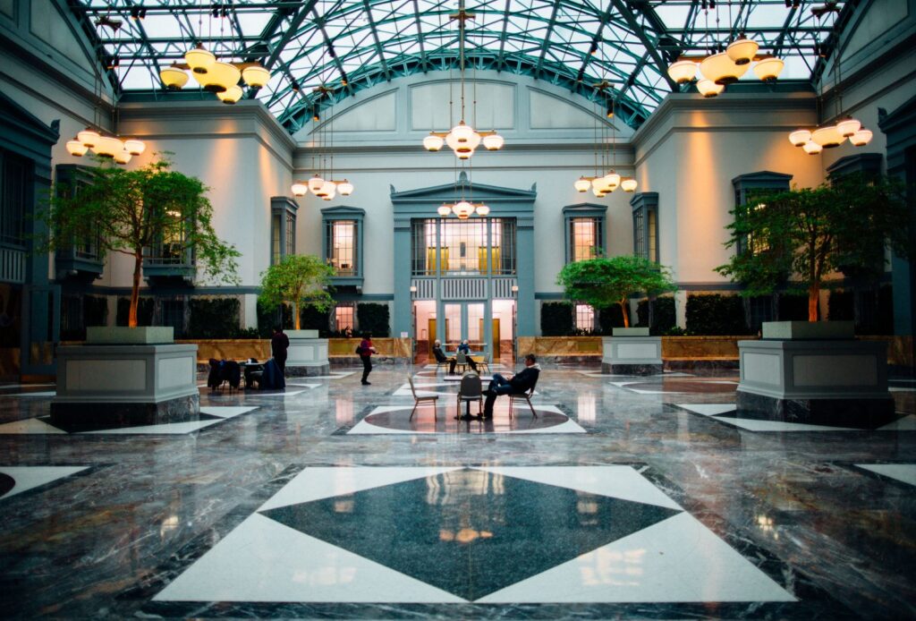 A bright commercial lobby with seating and plants, the kind of space a business buys a photo booth for