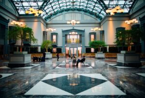 A bright commercial lobby with seating and plants, the kind of space a business buys a photo booth for