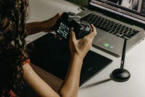 A photographer working between a tablet and a laptop, weighing up a LumaBooth alternative